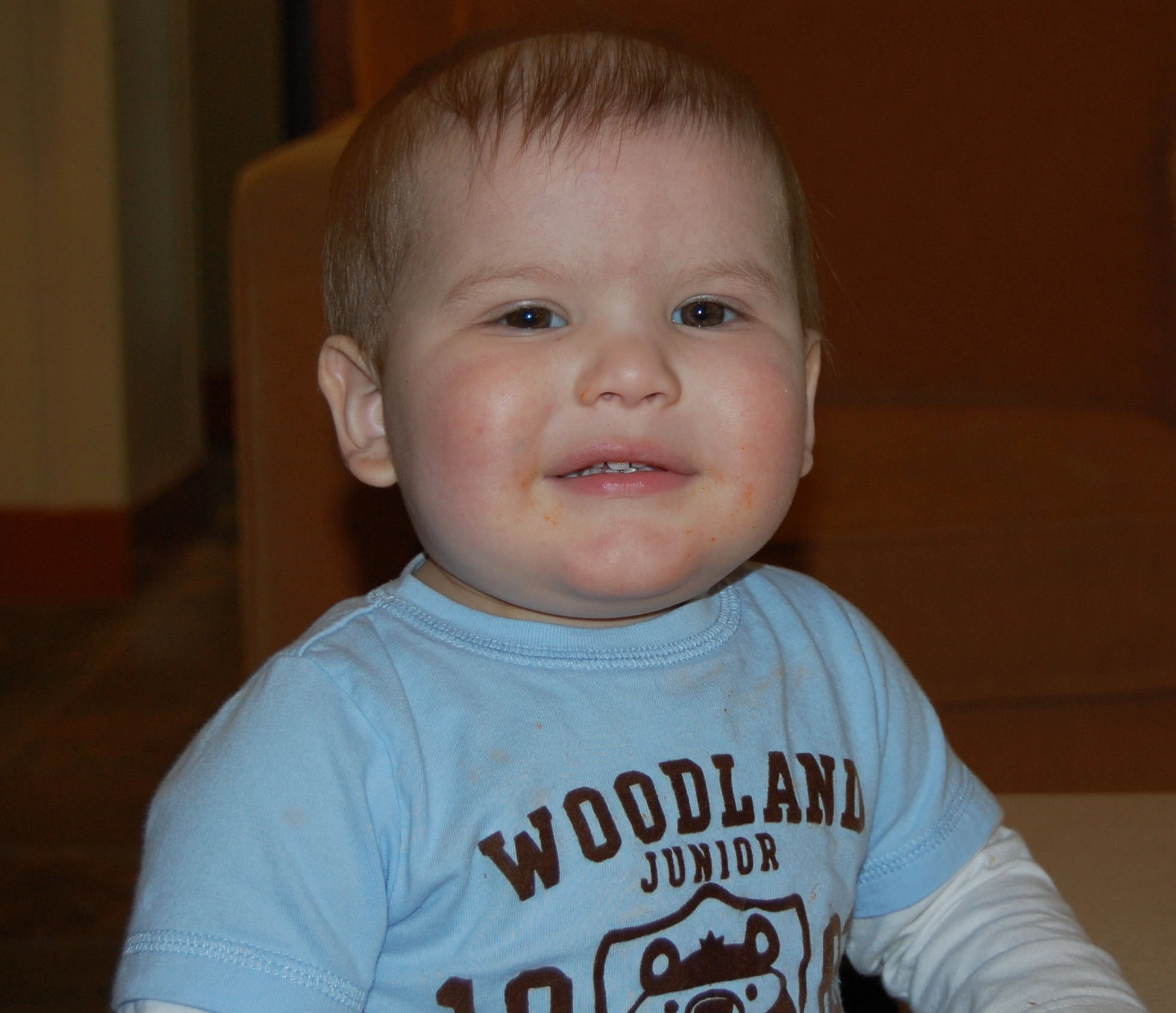 Kyler as a Baby boy in blue shirt smiling