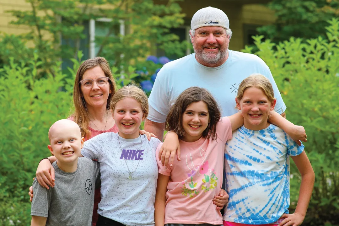 Creer family outside for family photo