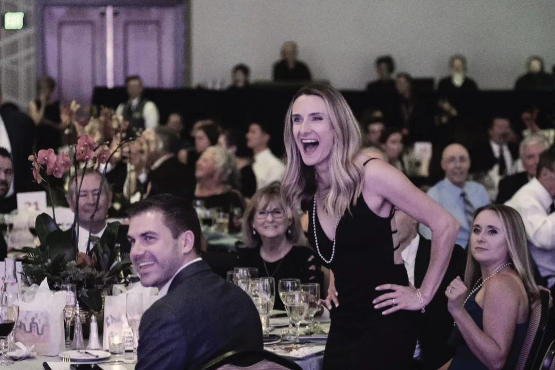 female adult in formal dress at fundraising gala event