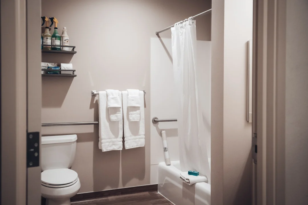 seattle house bathroom with tub shower and toilet, fresh linens on towel rack